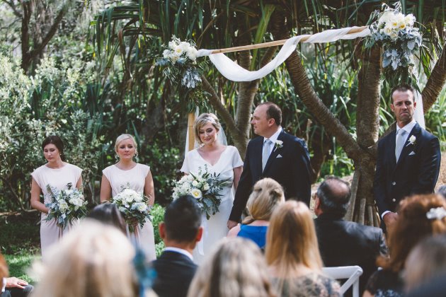 Sleek Bespoke Silk Dress For A Destination Beach Wedding wedding ceremony flower arch